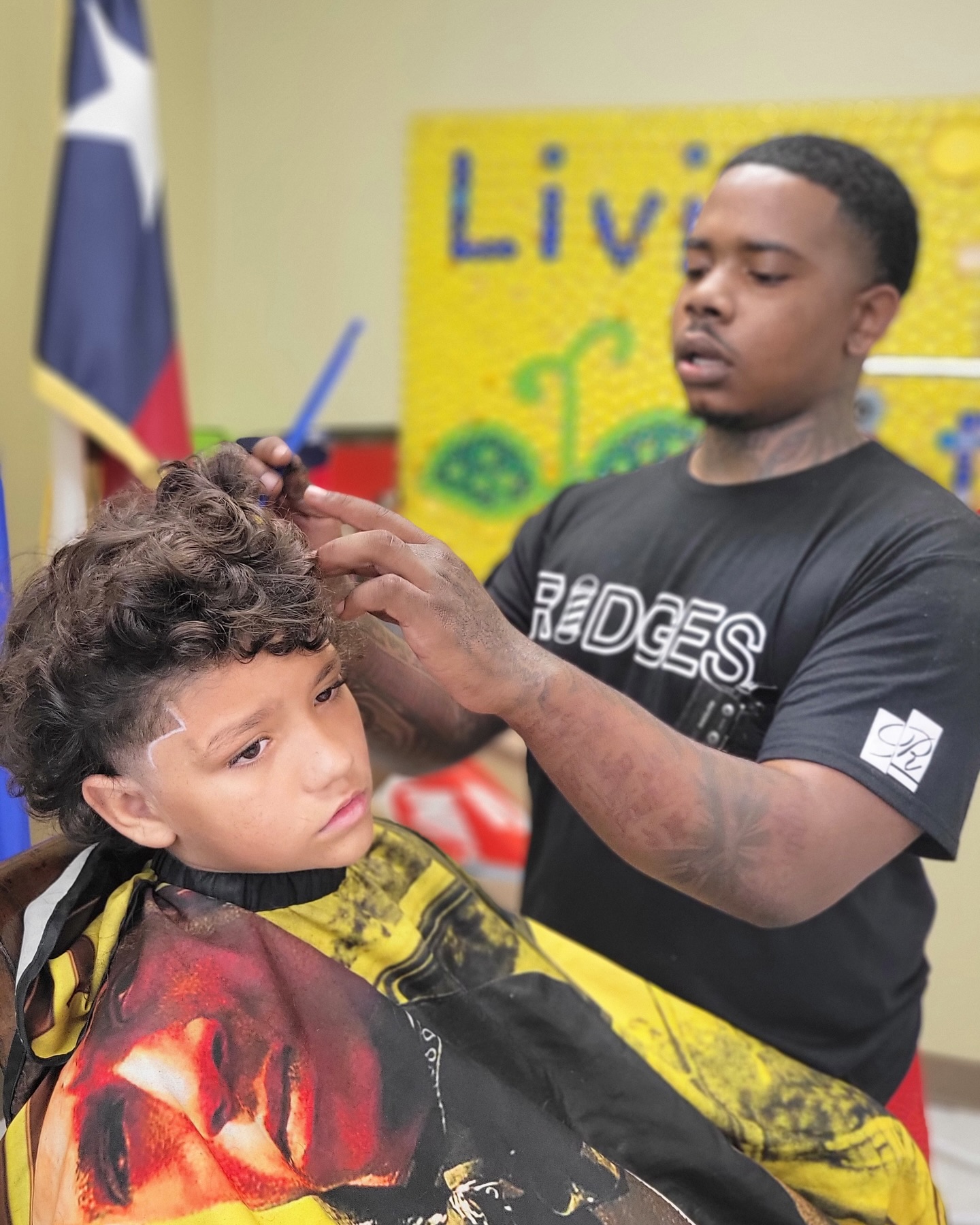 Barber giving a young boy a fresh haircut at the event