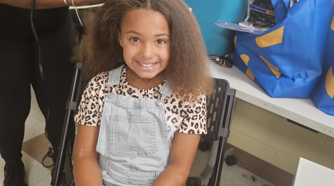 Smiling young girl after getting her hair styled