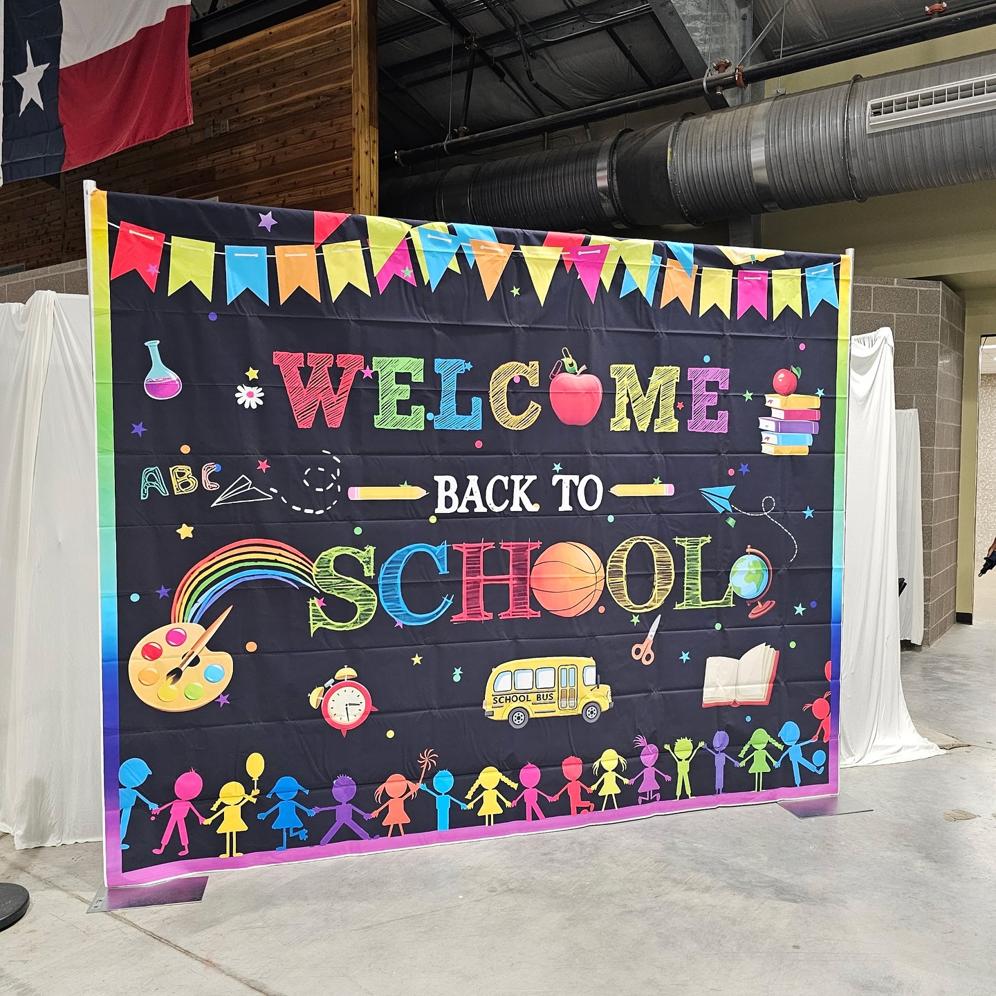 Kids holding the colorful Welcome Back to School banner